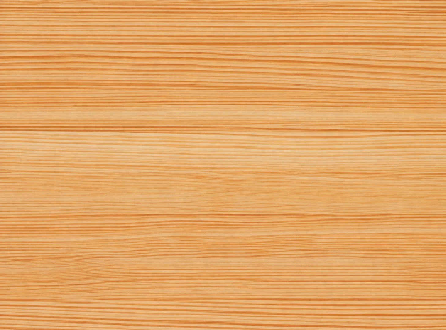 Gros plan sur une surface en bois clair aux fines veines horizontales de teinte orangée.